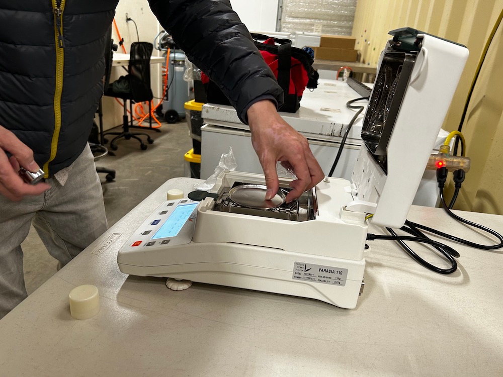 A person calibrating a moisture analyzer